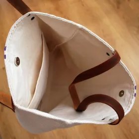 Sac rustique à rayures bleues et poignées en cuir à l'intérieur