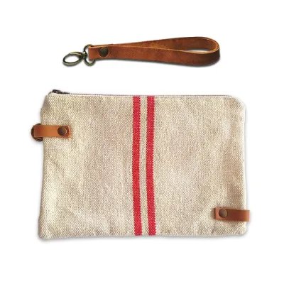 Rustic handbag with red stripes and leather handle, front view