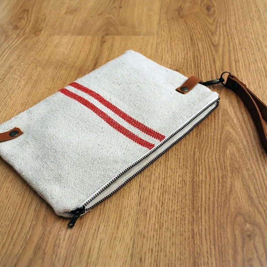 Bolsa de mano rústica rayas rojas asa piel vista diagonal suelo