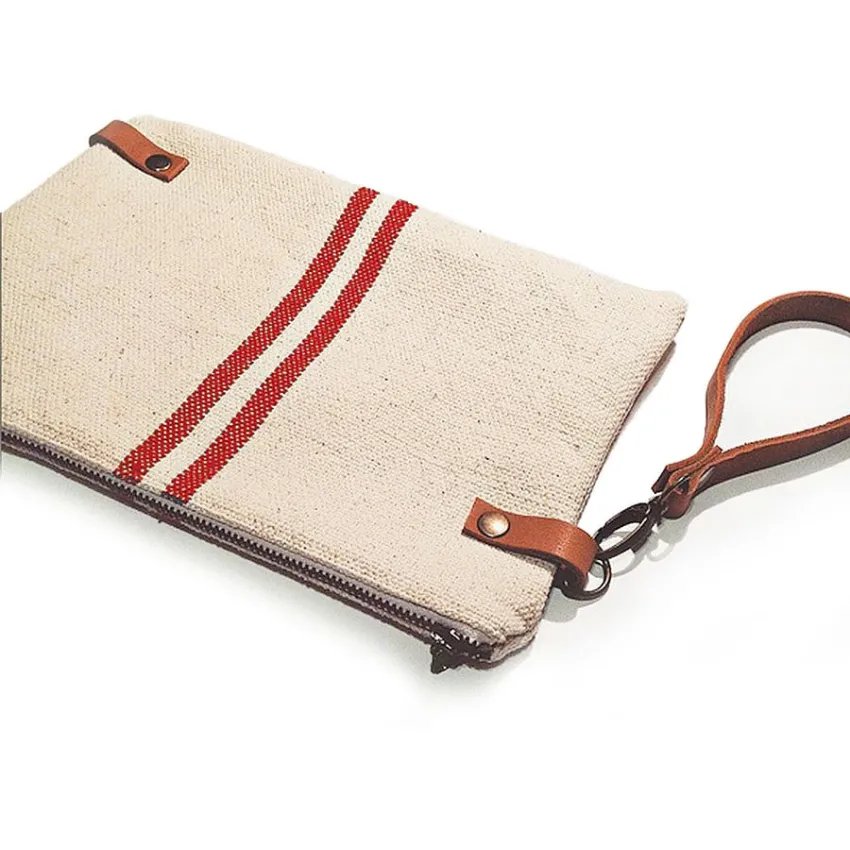 Rustic handbag with red stripes and diagonal leather handle